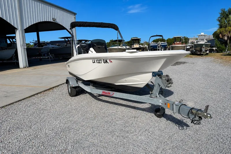 Slide: The Image of 2019 Boston Whaler 160 Super Sport boat on trailer, parked outdoors. - 4