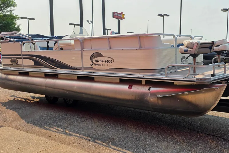 Slide: The Image of 2000 Lowe Suncruiser Trinidad 220 pontoon boat parked on a trailer in a lot. - 5