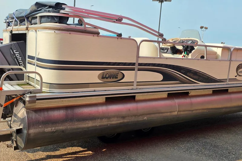 Slide: The Image of 2000 Lowe Suncruiser Trinidad 220 pontoon boat with Johnson outboard motor on trailer. - 3