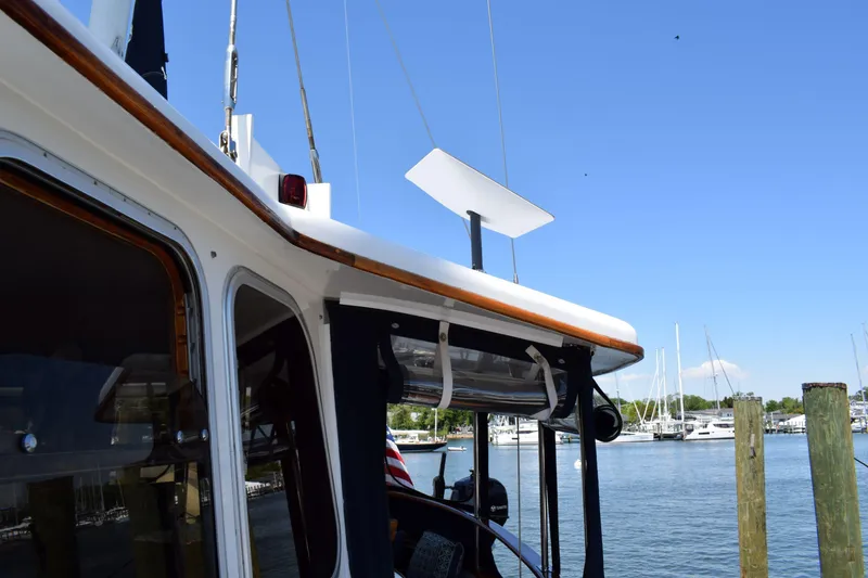 Slide: The Image of 1980 Cheoy Lee 52 Motorsailer docked, showcasing cabin and marina background. - 26