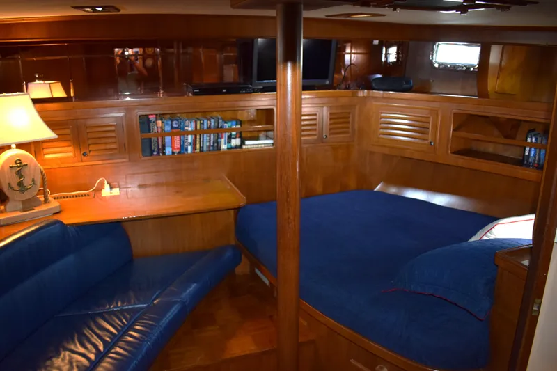 Slide: The Image of Luxurious 1980 Cheoy Lee 52 Motorsailer interior with cozy seating, bed, and wooden cabinetry. - 74