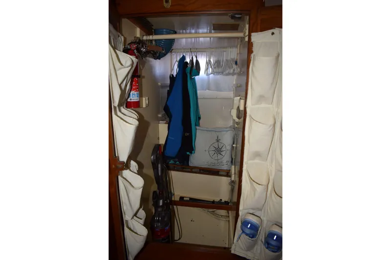 Slide: The Image of Interior closet of 1980 Cheoy Lee 52 Motorsailer with hanging clothes and storage. - 66