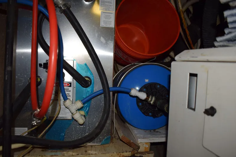 Slide: The Image of Engine room of 1980 Cheoy Lee 52 Motorsailer with hoses and equipment. - 98