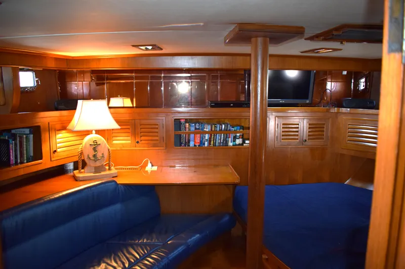 Slide: The Image of Interior of 1980 Cheoy Lee 52 Motorsailer with cozy seating, lamp, and bookshelf. - 73