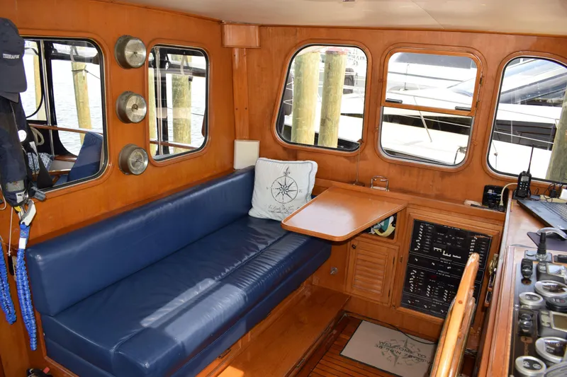 Slide: The Image of Interior of 1980 Cheoy Lee 52 Motorsailer with blue seating and wooden accents. - 42
