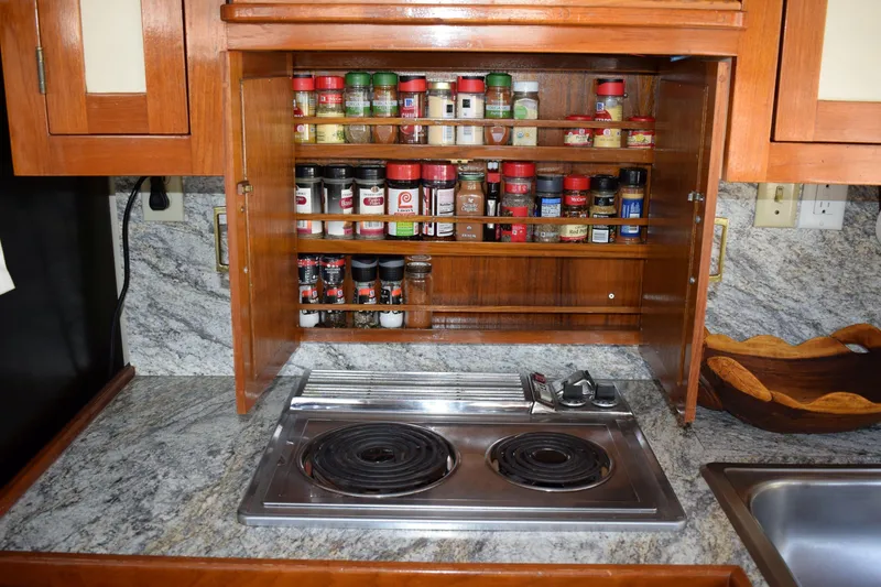 Slide: The Image of Galley kitchen in 1980 Cheoy Lee 52 Motorsailer with spice rack and electric stove. - 62