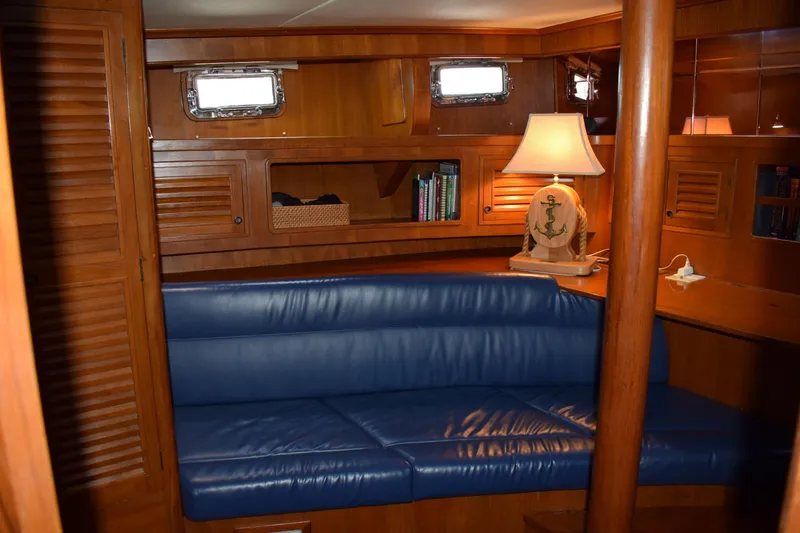 Slide: The Image of Interior of 1980 Cheoy Lee 52 Motorsailer with blue seating and nautical-themed decor. - 71