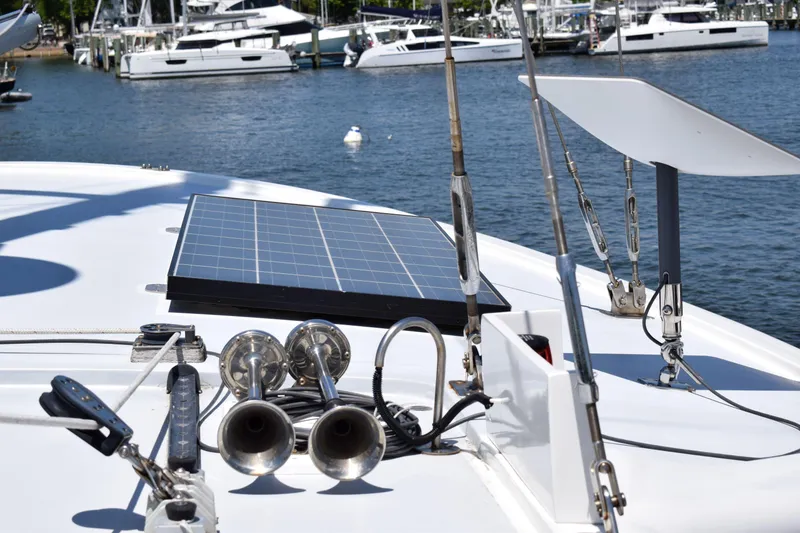 Slide: The Image of 1980 Cheoy Lee 52 Motorsailer deck with solar panel and horns in marina. - 28