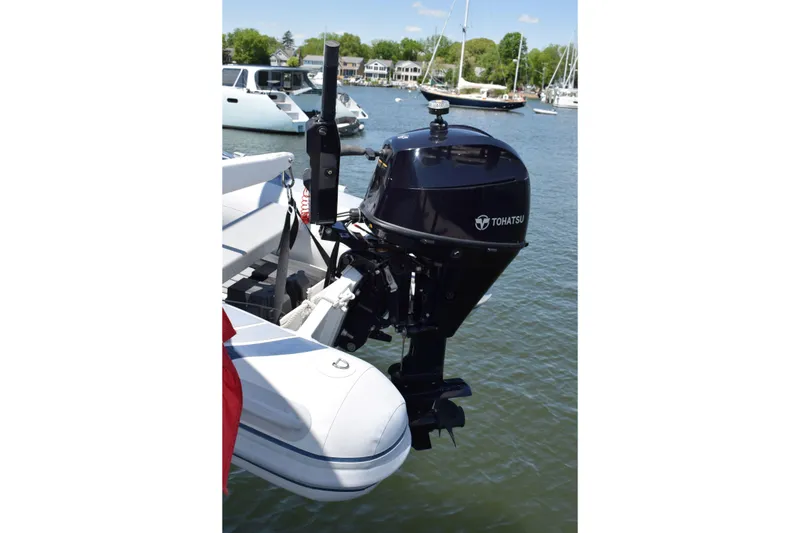 Slide: The Image of Tohatsu outboard motor on a Cheoy Lee 52 Motorsailer, 1980, docked in a marina. - 32