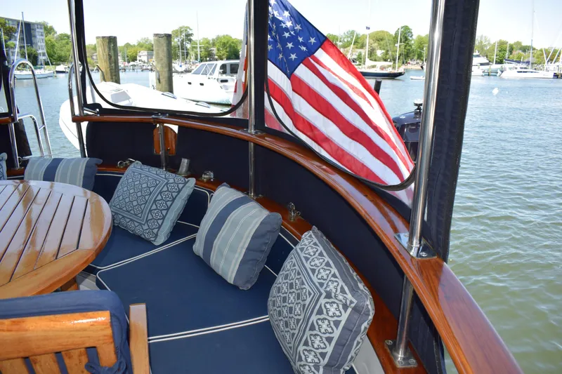 Slide: The Image of Cozy seating area on 1980 Cheoy Lee 52 Motorsailer with American flag. - 38