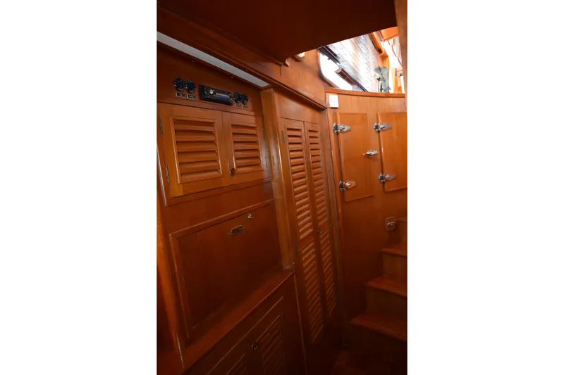 Slide: The Image of Interior of 1980 Cheoy Lee 52 Motorsailer with wooden cabinetry and steps. - 84