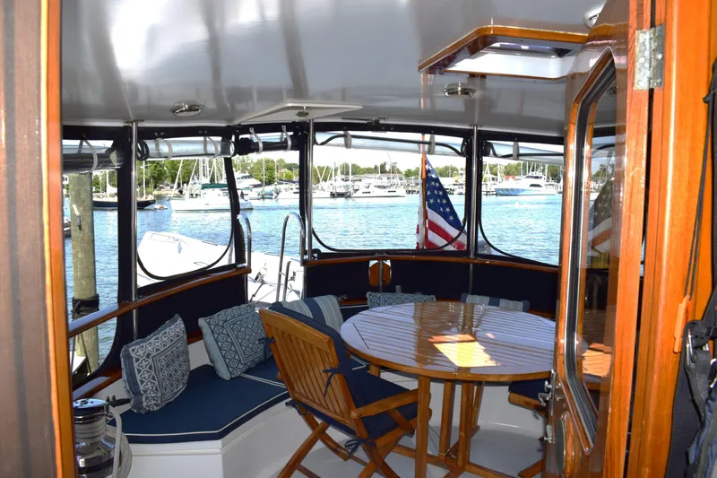 Slide: The Image of Interior view of 1980 Cheoy Lee 52 Motorsailer with seating and table, overlooking marina. - 34