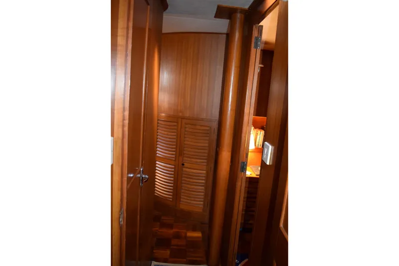 Slide: The Image of Interior of 1980 Cheoy Lee 52 Motorsailer with wooden cabinetry and cozy lighting. - 77