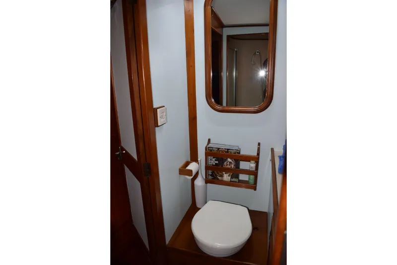 Slide: The Image of Compact bathroom in 1980 Cheoy Lee 52 Motorsailer with wooden accents and mirror. - 92