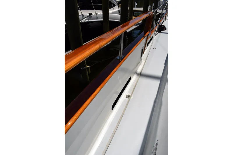 Slide: The Image of 1980 Cheoy Lee 52 Motorsailer deck with polished wood railing. - 18