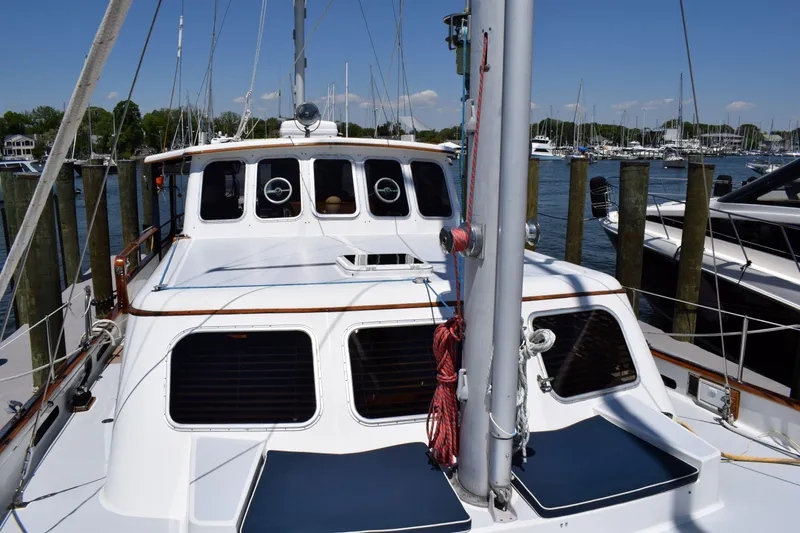 Slide: The Image of 1980 Cheoy Lee 52 Motorsailer docked at marina, showcasing deck and cabin features. - 22