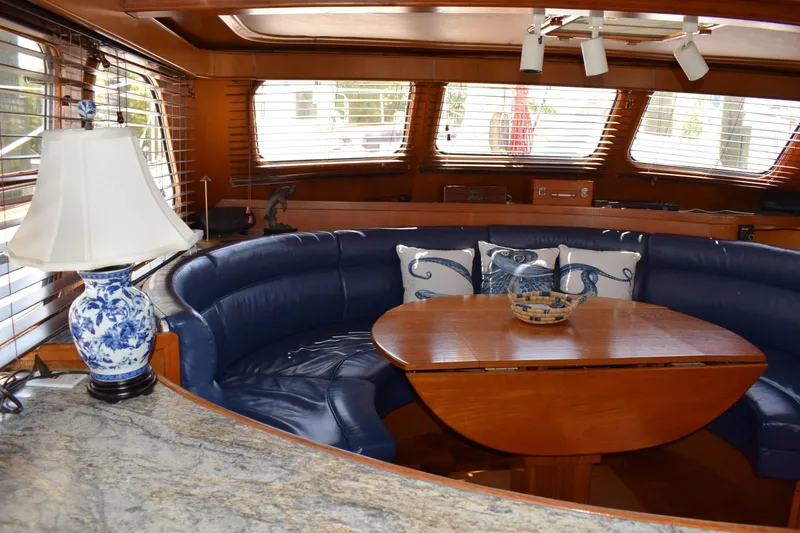 Slide: The Image of Luxurious interior of 1980 Cheoy Lee 52 Motorsailer with blue seating and elegant decor. - 55