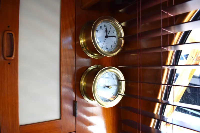 Slide: The Image of Brass clock and barometer on 1980 Cheoy Lee 52 Motorsailer interior wood paneling. - 43