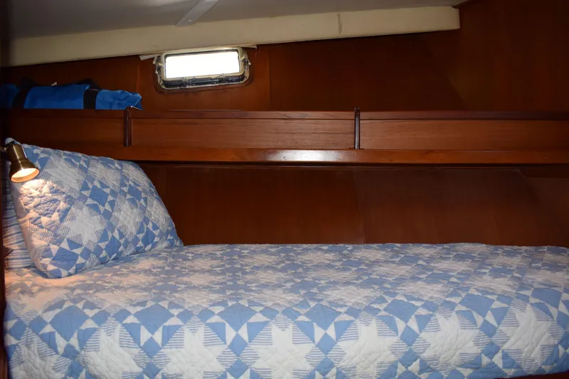 Slide: The Image of Cozy cabin interior of 1980 Cheoy Lee 52 Motorsailer with quilted bedding and wooden finish. - 79