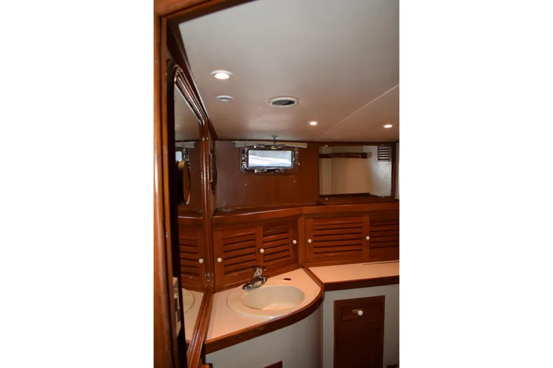 Slide: The Image of Interior of 1980 Cheoy Lee 52 Motorsailer bathroom with wooden cabinetry and sink. - 69