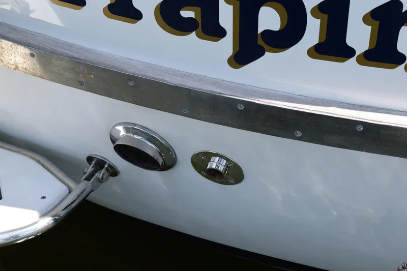 Slide: The Image of 1980 Cheoy Lee 52 Motorsailer stern detail with metal fittings and partial lettering. - 13