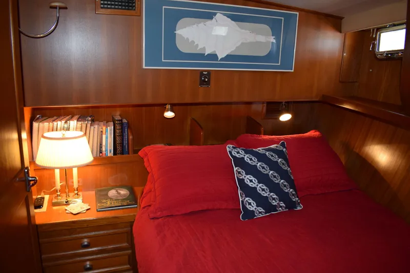Slide: The Image of Cozy cabin interior of 1980 Cheoy Lee 52 Motorsailer with red bedding and nautical decor. - 87