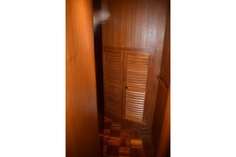 Slide: The Image of Wooden interior of 1980 Cheoy Lee 52 Motorsailer, featuring louvered cabinet doors. - 78