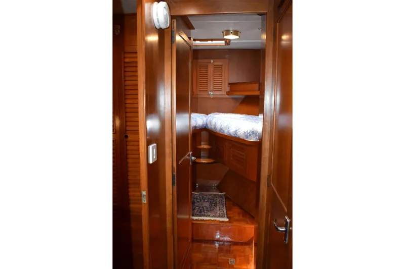 Slide: The Image of Cozy wooden cabin interior of 1980 Cheoy Lee 52 Motorsailer with bed and rug. - 82