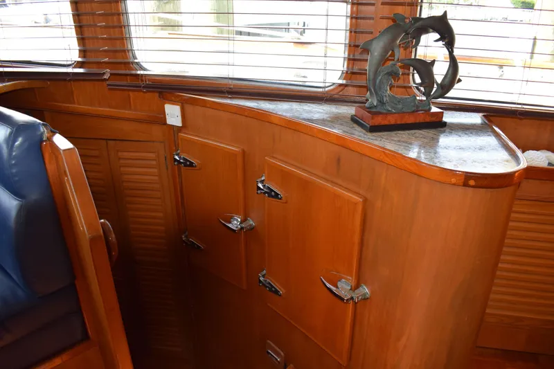 Slide: The Image of Interior of 1980 Cheoy Lee 52 Motorsailer with wooden cabinetry and dolphin sculpture. - 86