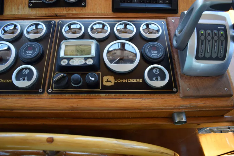 Slide: The Image of Control panel of a 1980 Cheoy Lee 52 Motorsailer with John Deere gauges and controls. - 51