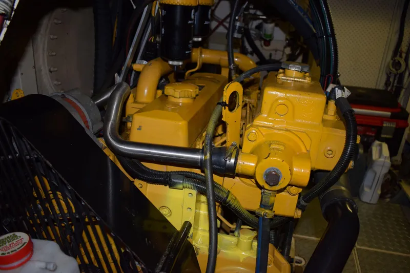 Slide: The Image of Engine room of 1980 Cheoy Lee 52 Motorsailer with yellow machinery components. - 99