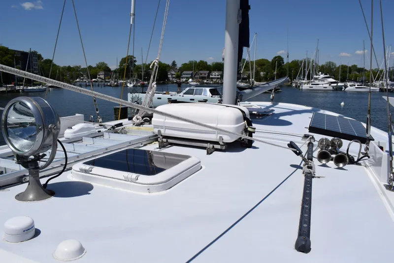 Slide: The Image of 1980 Cheoy Lee 52 Motorsailer deck with solar panels and marina view. - 27