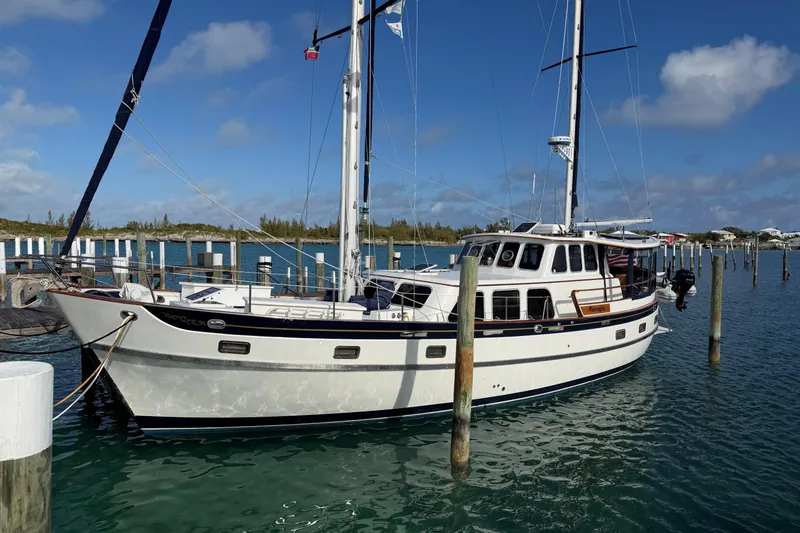 The Image of 1980 Cheoy Lee 52 Motorsailer docked in a sunny marina setting. - 0