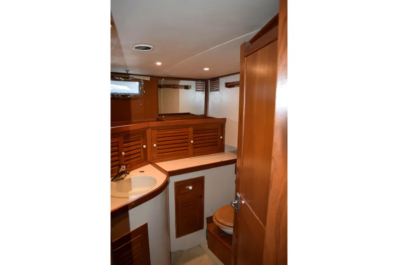 Slide: The Image of Interior of 1980 Cheoy Lee 52 Motorsailer bathroom with wooden cabinetry and sink. - 67
