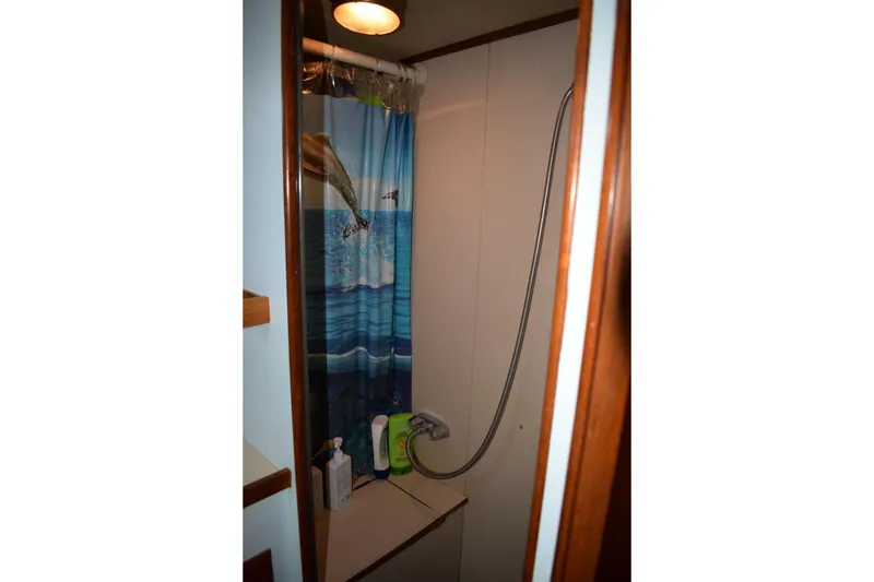 Slide: The Image of Shower area in 1980 Cheoy Lee 52 Motorsailer with dolphin-themed curtain. - 91