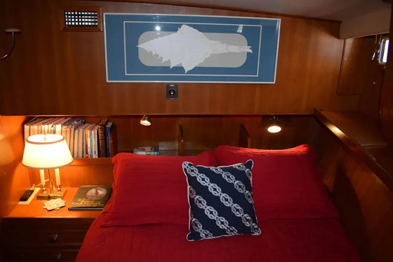 Slide: The Image of Cozy cabin interior of 1980 Cheoy Lee 52 Motorsailer with red bedding and nautical decor. - 88
