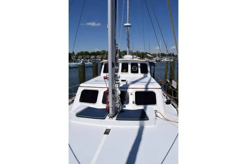 Slide: The Image of 1980 Cheoy Lee 52 Motorsailer docked, showcasing deck and cabin details. - 23