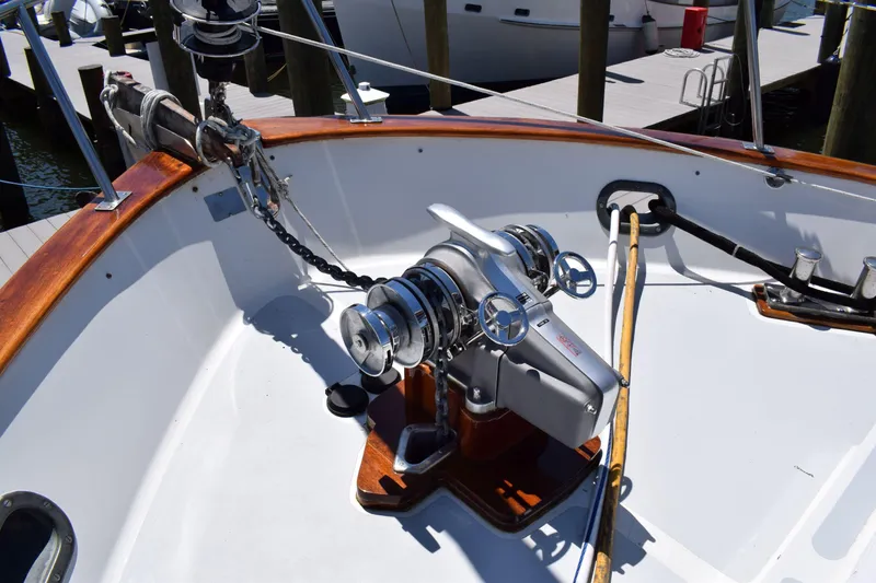 Slide: The Image of Deck of 1980 Cheoy Lee 52 Motorsailer with winch and wooden accents. - 21