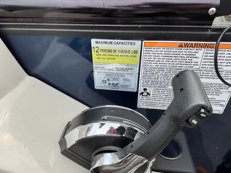 Slide: The Image of Close-up of a control lever with capacity labels for 12 persons or 1695 pounds. - 3