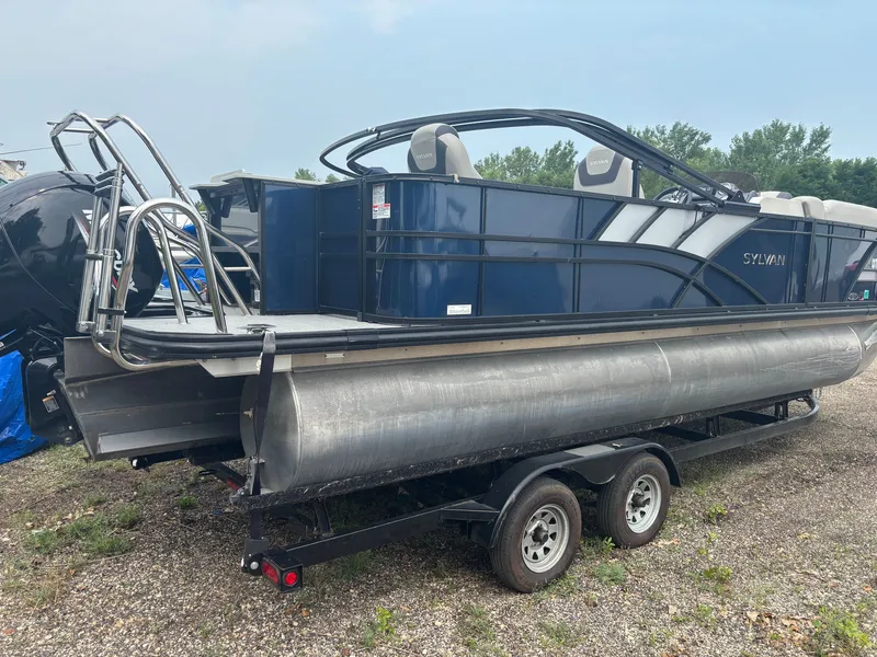 Slide: The Image of 2021 Sylvan L3PF Tritoon on a trailer, featuring blue paneling and stainless steel railings. - 13