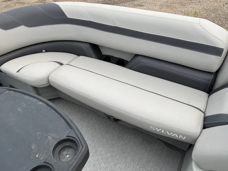 Slide: The Image of The image shows a sleek, gray seating area on a 2021 Sylvan L3PF TRITOON. - 12