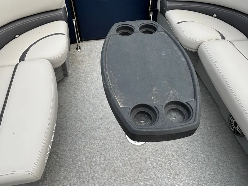 Slide: The Image of Interior of a 2021 Sylvan L3PF TRITOON with a gray table and seating. - 8