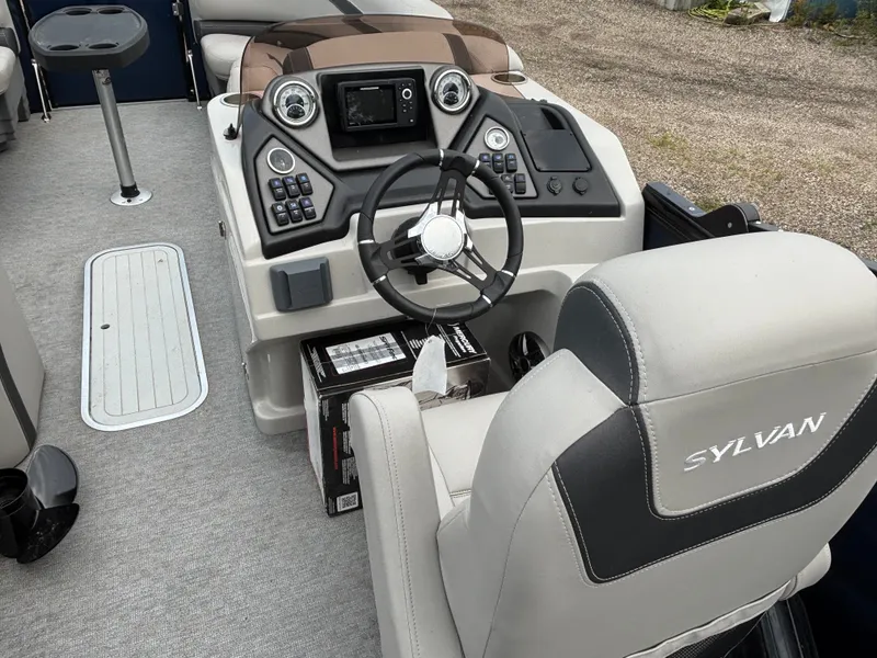 Slide: The Image of The image shows the cockpit of a 2021 Sylvan L3PF TRITOON with a modern helm station. - 9
