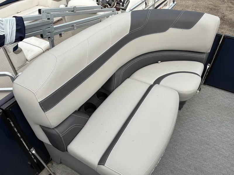 Slide: The Image of The image shows an elegant, curved bench seat with gray and white upholstery on a boat. - 6