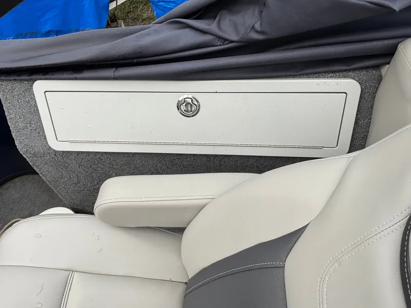 Slide: The Image of Close-up of a white seat and storage compartment on a boat. - 4