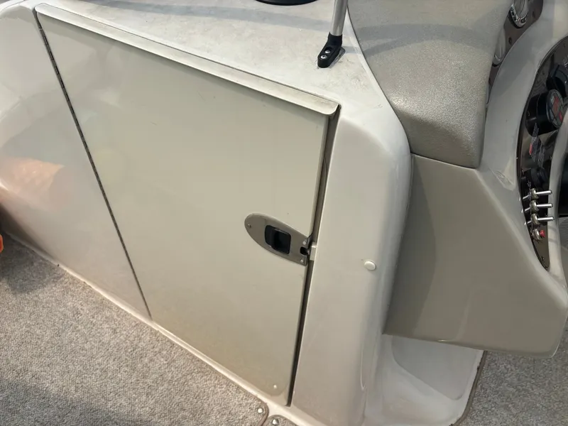 Slide: The Image of The cabin door of a 2005 Sea Ray 240 Sundeck with gray carpet flooring. - 15