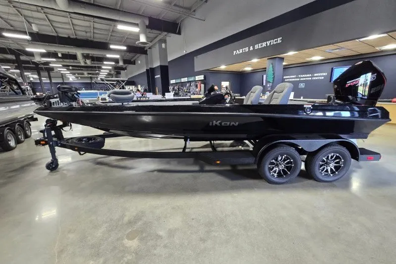 The Image of 2027 iKon VLX21 boat on trailer in showroom, parts and service area visible. - 0