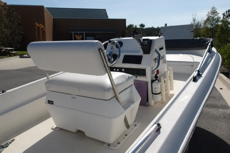 Slide: The Image of 2002 Wellcraft 160 Fisherman boat interior with steering console and seating. - 1