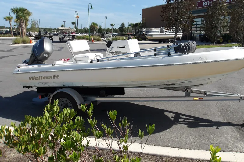 Slide: The Image of 2002 Wellcraft 160 Fisherman boat on trailer in parking lot. - 2