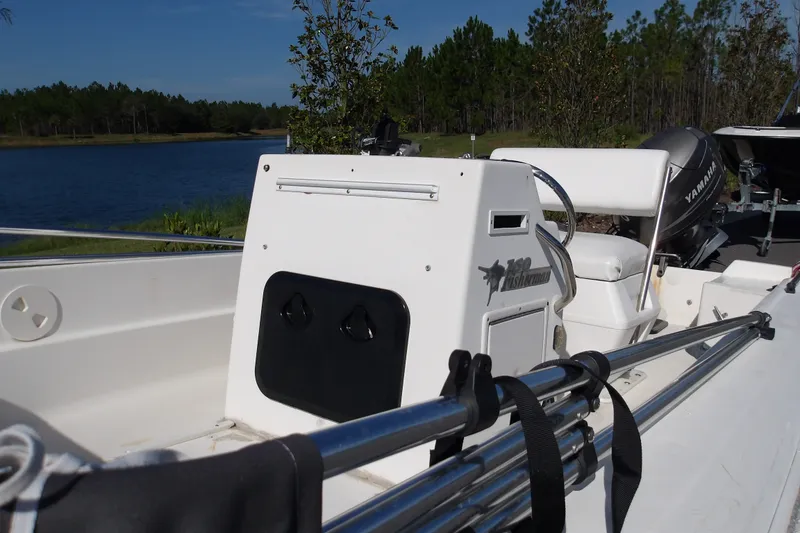 Slide: The Image of 2002 Wellcraft 160 Fisherman boat interior with Yamaha motor by a lake. - 6